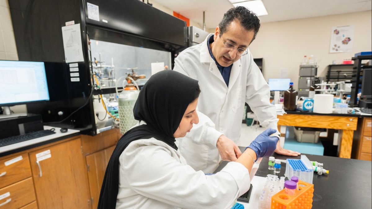 a professor and a graduate student work together in a lab